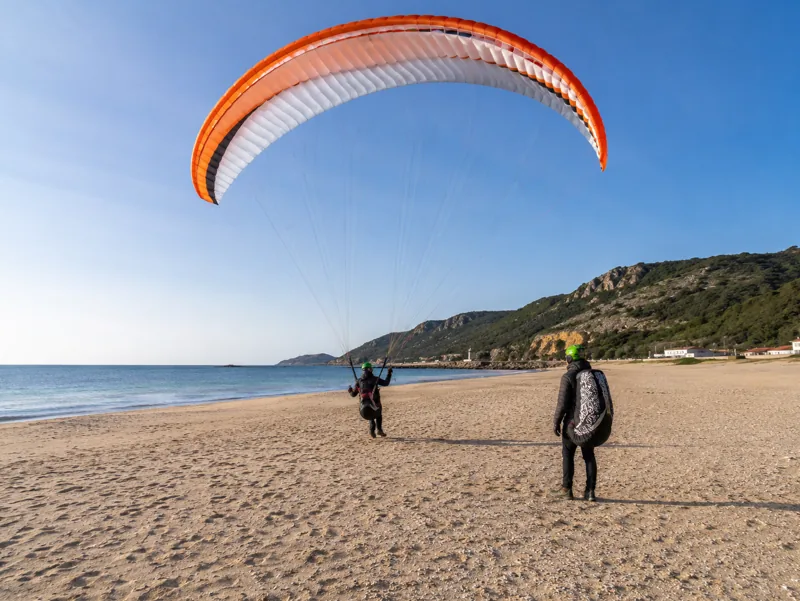 Beginner pilot learning to paraglide on the beach