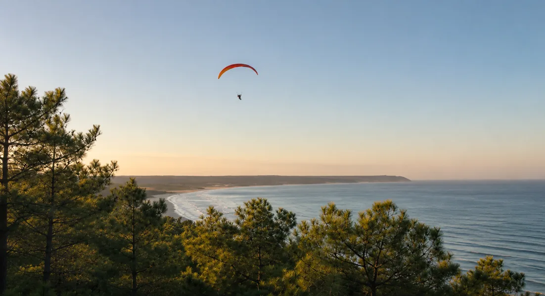 Paraglider at golden dusk above the Atlantic