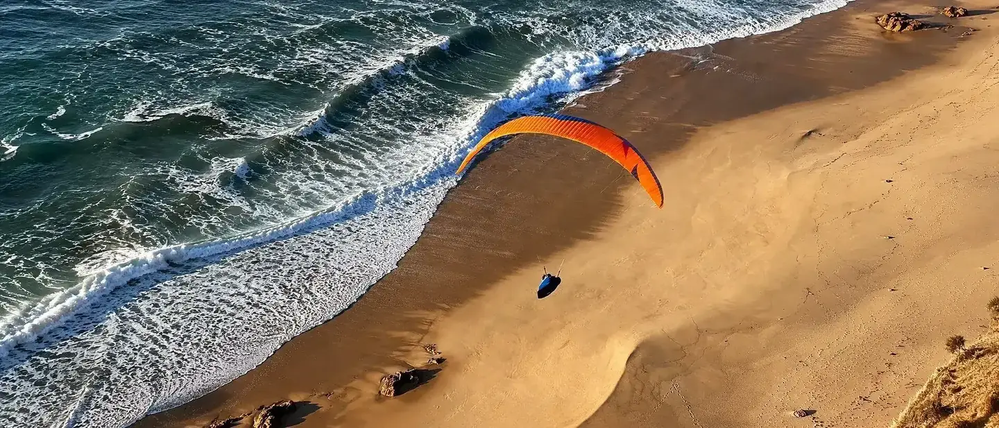 Paragliding over the Sesimbra coastline, Portugal