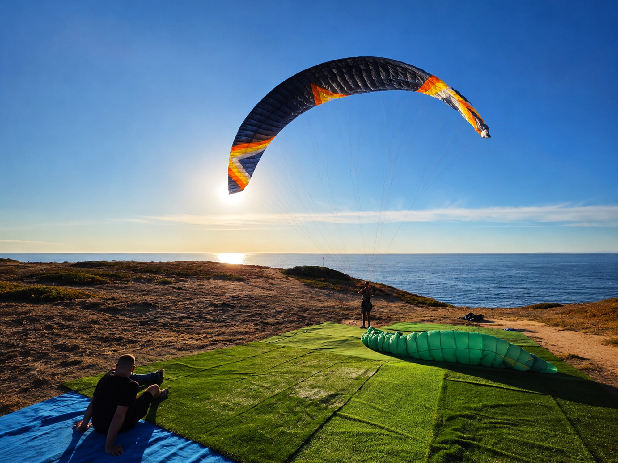 Parakite skills training at a Portuguese coastal launch in golden hour