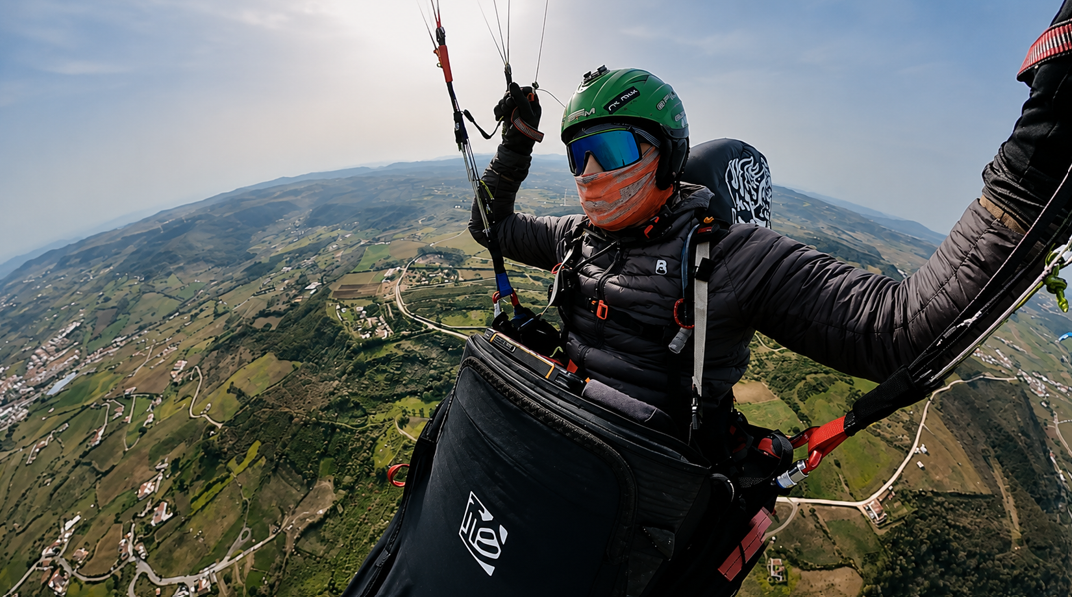 Behrooz Jafarzadeh in his green helmet soaring XC above the rolling hills of inland Portugal